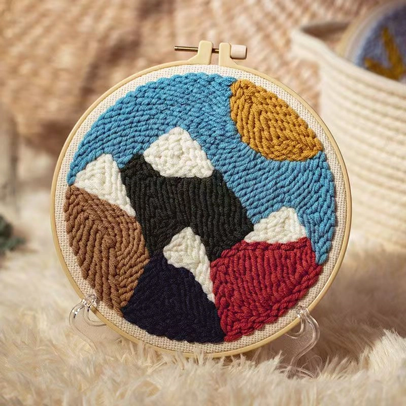 Layered Peaks Mountain Punch Needle Art Kit Layered peaks punch needle art kit with geometric mountain silhouettes in wooden hoop, yarn, and beginner crafting tools