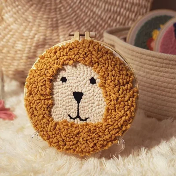 Little Lion Punch Needle Design Kit for Beginners Little lion punch needle design kit with adorable lion face pattern in wooden hoop, yarn, and beginner crafting materials
