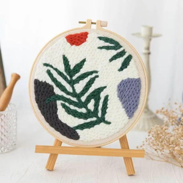 Wild Leaves Botanical Punch Needle Embroidery Kit Punch needle embroidery kit featuring wild leaves botanical pattern in wooden hoop with green yarns and crafting tools for beginners