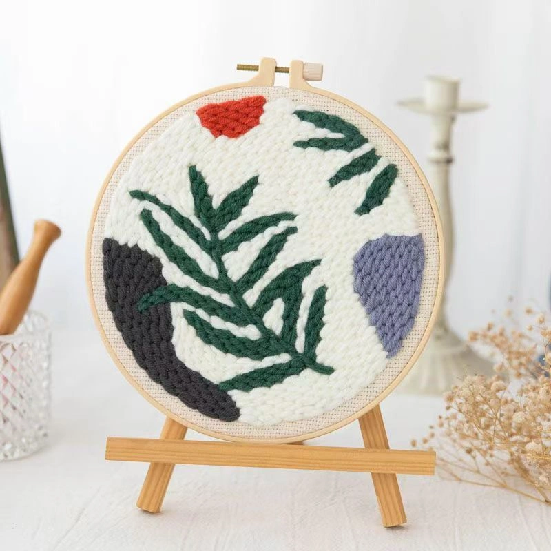 Wild Leaves Botanical Punch Needle Embroidery Kit Punch needle embroidery kit featuring wild leaves botanical pattern in wooden hoop with green yarns and crafting tools for beginners