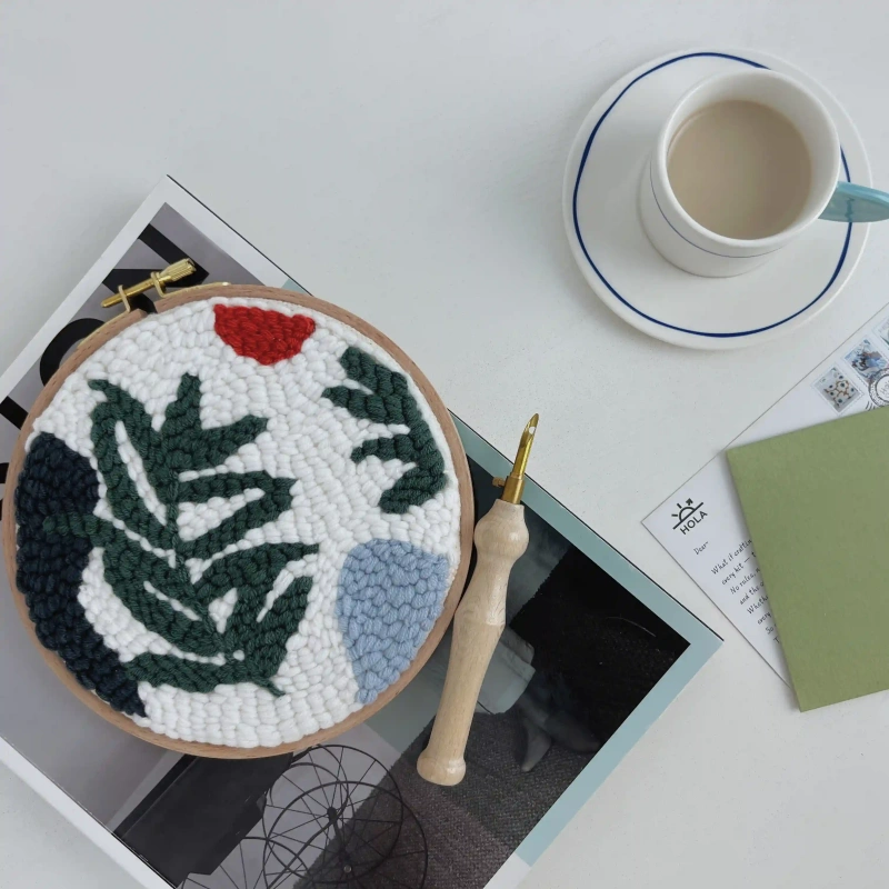 Punch Needle Embroidery Wild Leaves - Cozy Crafting Lifestyle Scene Punch needle embroidery wild leaves design displayed with coffee cup and magazines in cozy lifestyle crafting scene
