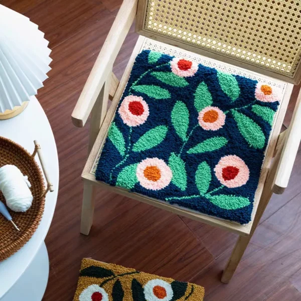 Blue Roses Punch Needle Pillow — A Burst of Color for Your Chair Blue floral punch needle pillow on wooden chair, featuring handmade texture and vibrant colors.