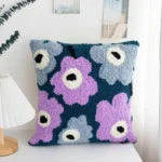 Purple Flowers Punch Needle Pillow Kit Purple flowers punch needle pillow kit showing finished cushion with floral design and crafting materials