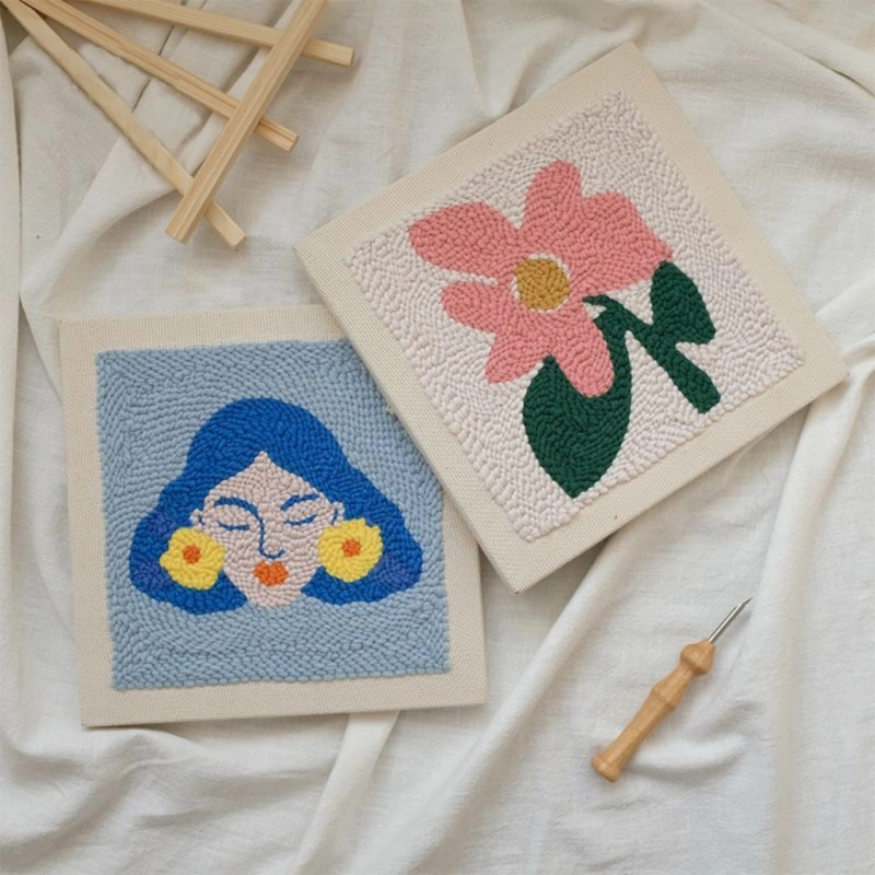 Frida Kahlo and Flower Wall Art Punch Needle Kits Wall art punch needle kits of Frida Kahlo with blue portrait and pink flower design, crafting tools on white fabric