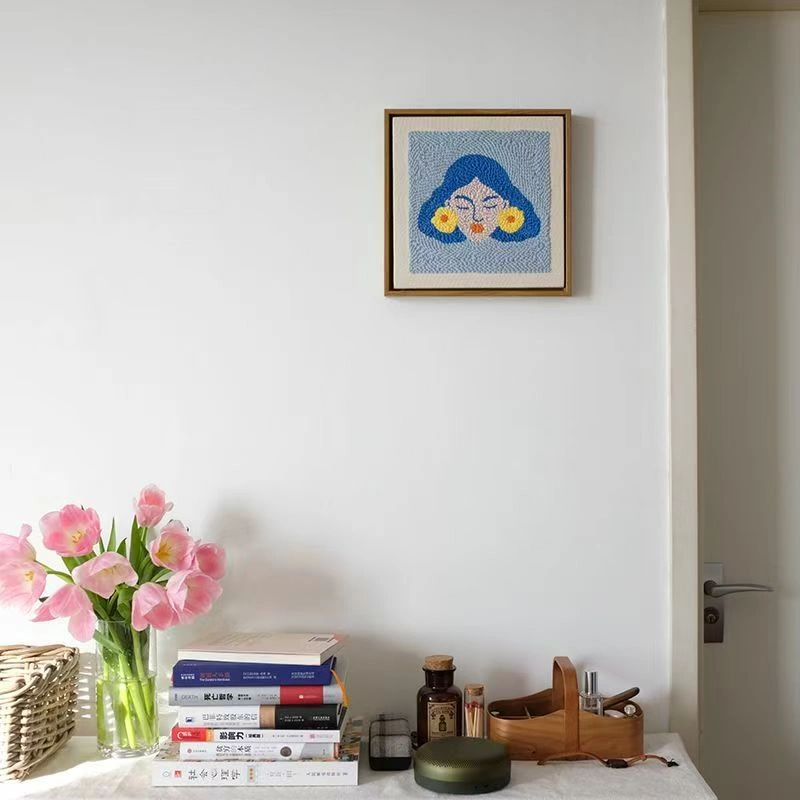 Frida Kahlo Wall Art Framed Abstract Portrait Home Decor Framed Frida Kahlo wall art with blue hair and yellow flowers hanging above desk with pink tulips and books