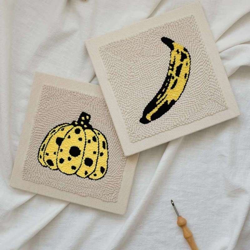 Artist Series Punch Needle Kits - Warhol Banana & Kusama Pumpkin Collection Two punch needle canvases featuring Andy Warhol banana and Yayoi Kusama pumpkin designs, artist series craft collection