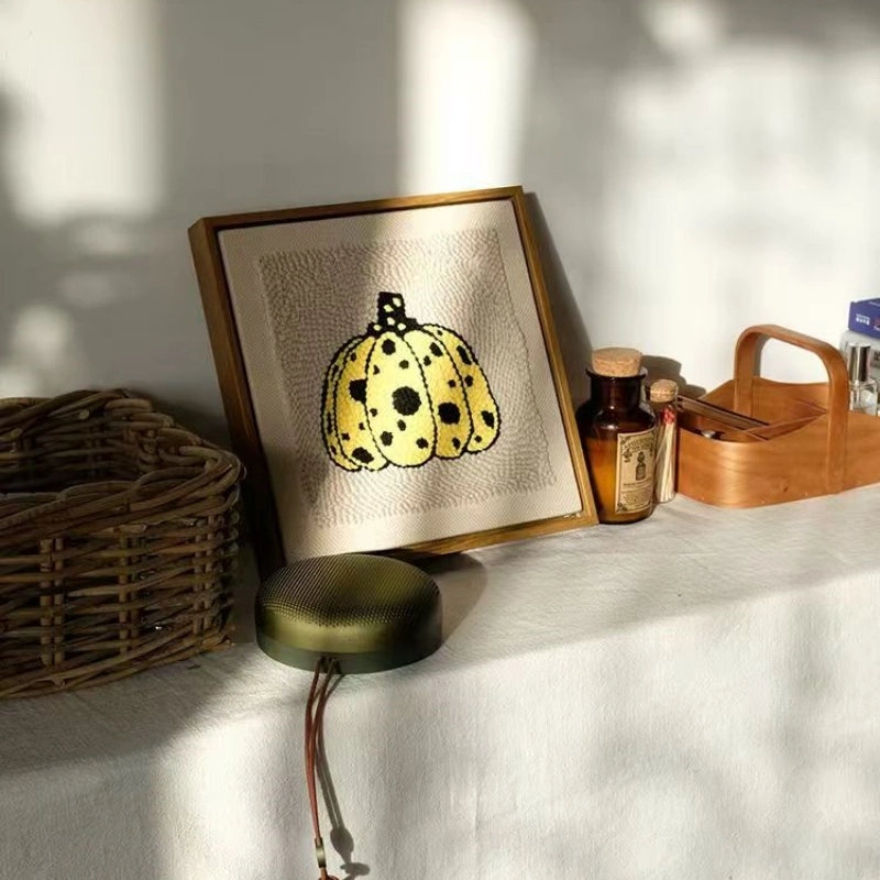 Framed Yayoi Kusama Pumpkin Punch Needle Art - Modern Home Decor Framed yellow spotted pumpkin punch needle artwork in golden frame on white table