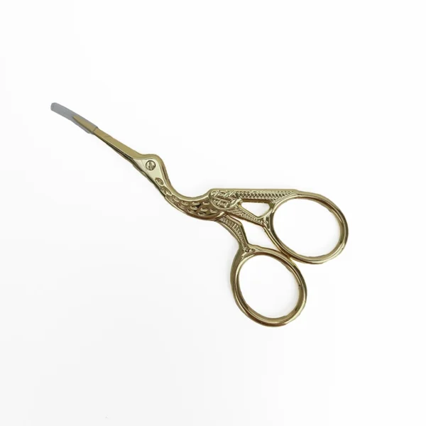 Premium Gold Stork Embroidery Scissors - Intricate Design Detail View Close-up view of ornate gold stork embroidery scissors showing detailed craftsmanship and elegant curved design
