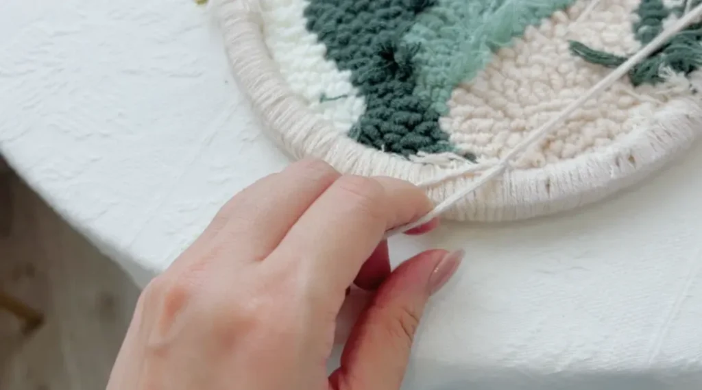 Tying a knot close to the finished stitches to lock the yarn in place.