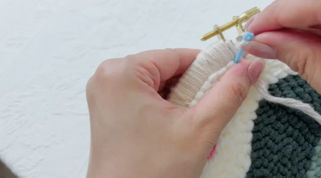 Completing the final round of stitches around the hoop edge.