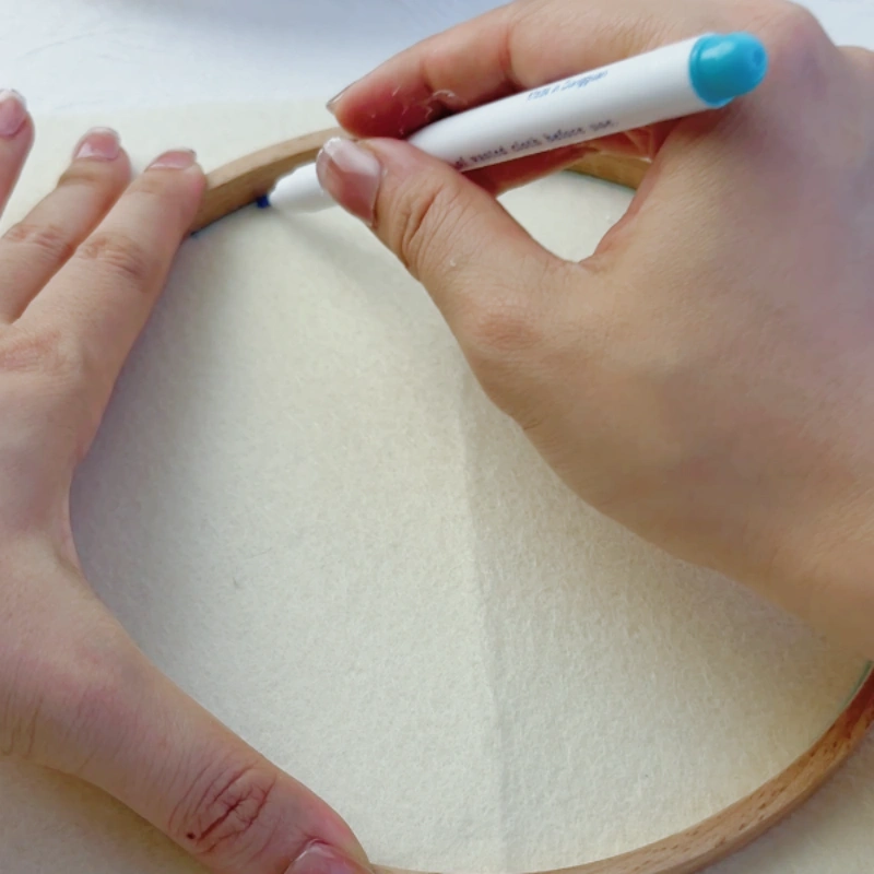 Tracing a circle on felt backing using the inner hoop ring.