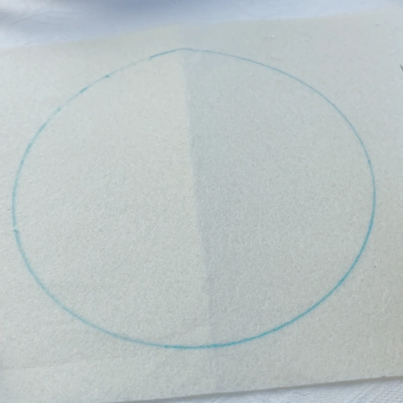 Drawing a complete circular backing board on felt.