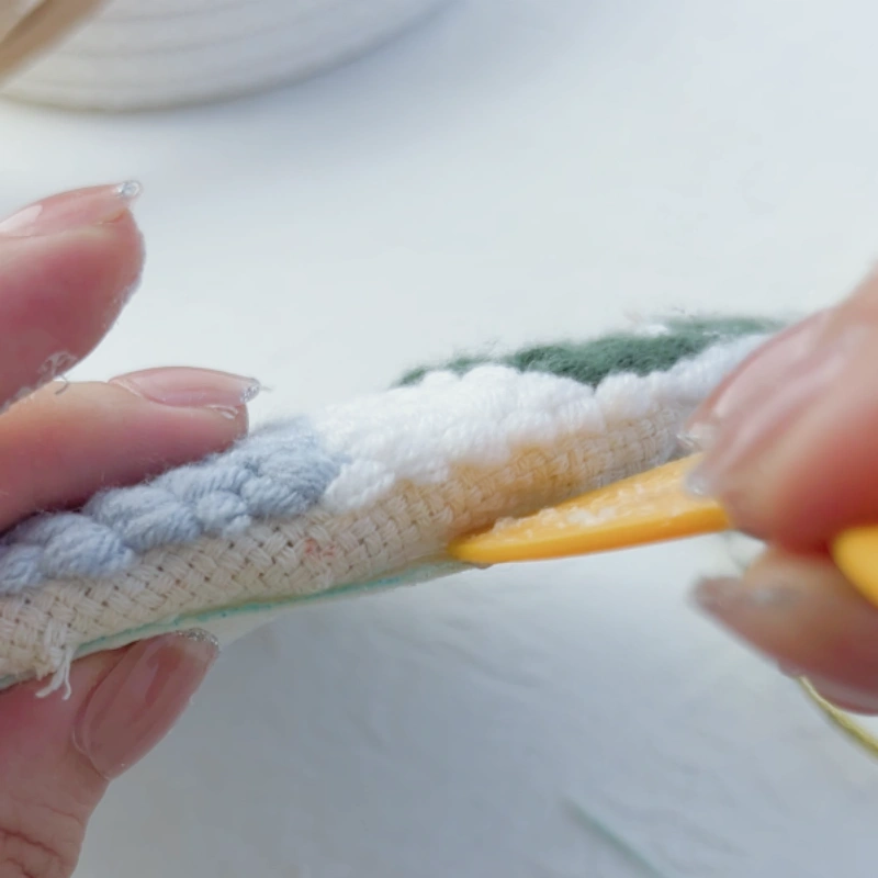 Spreading additional glue evenly with a scraper.