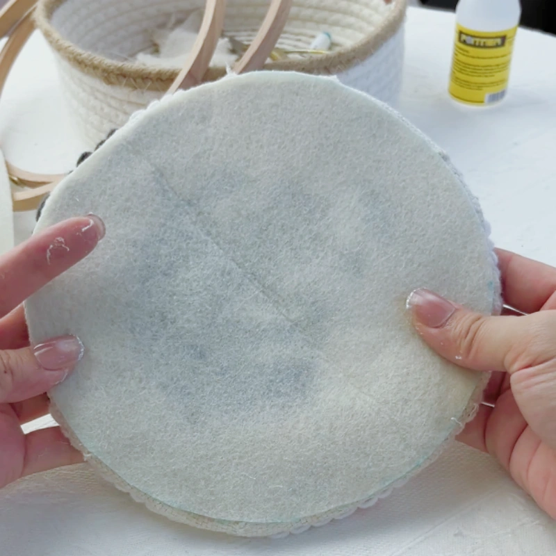 Back view of a fully glued felt backing on the hoop embroidery.