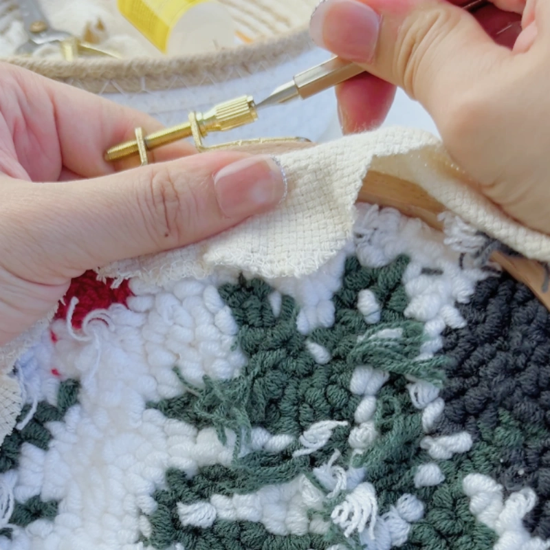 Loosening the hoop screw with a flat-head screwdriver.