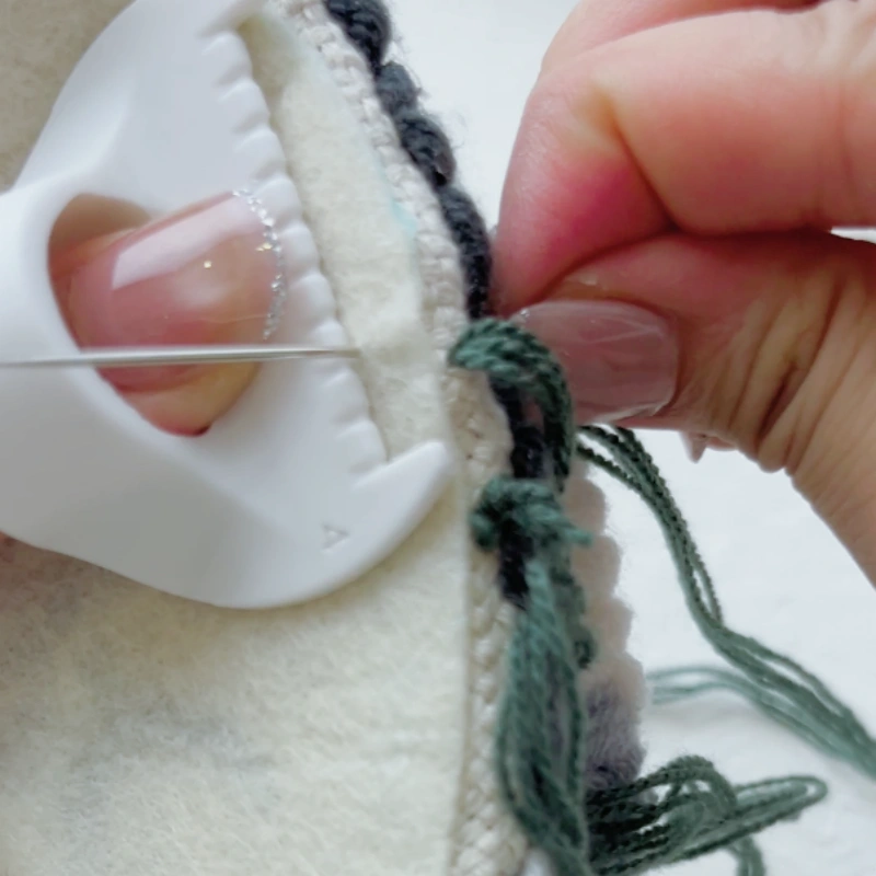 Using an edge stitch lock sewing gauge to guide stitch spacing.