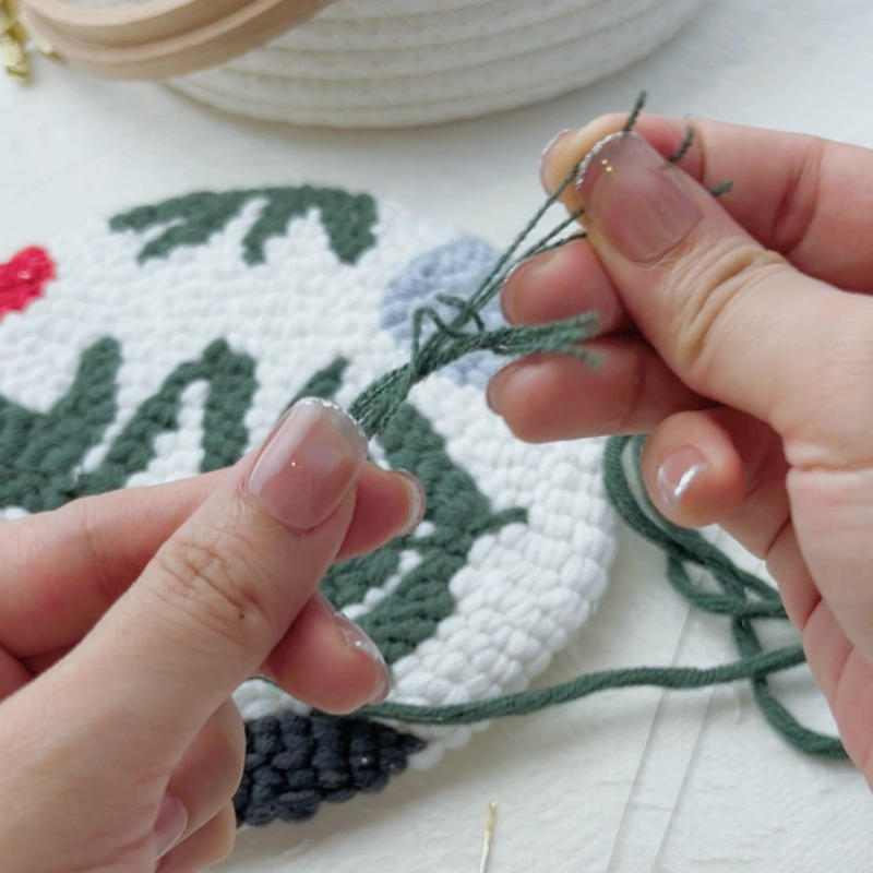 Pulling out single strands of yarn from a bundle for stitching.