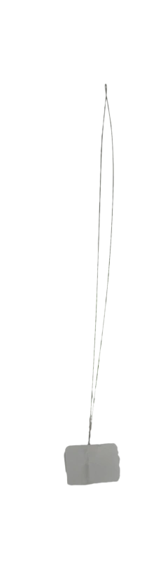 Threading yarn through a punch needle using a needle threader.