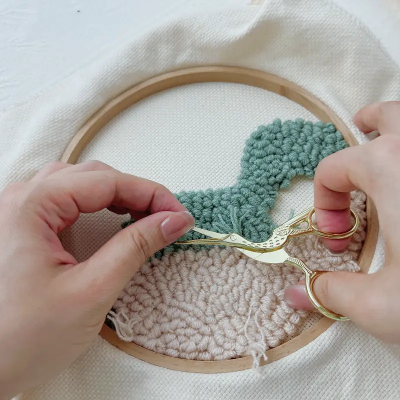 Completed off-white block – trim excess yarn at back of hoop